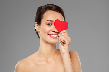 Image showing beautiful woman closing one eye with pink heart