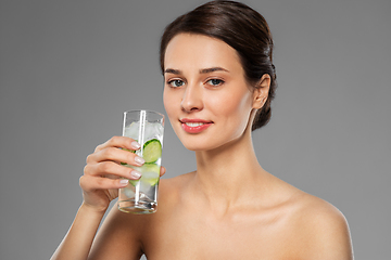 Image showing woman drinking water with cucumber and ice