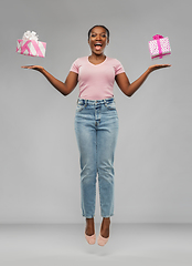 Image showing happy african american woman with gift boxes