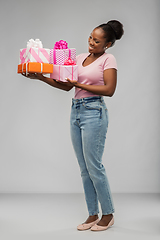 Image showing happy african american woman with gift boxes