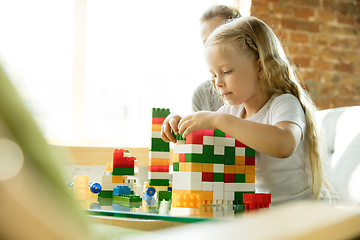 Image showing Teacher and little girl, or mom and daughter. Homeschooling concept