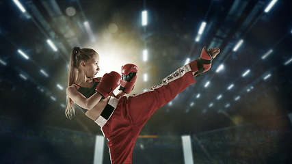 Image showing Young female kickboxing fighter training in the gym