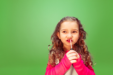 Image showing Little girl dreaming about future profession of makeup artist