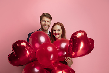 Image showing Valentine\'s day celebration, happy caucasian couple isolated on coral background