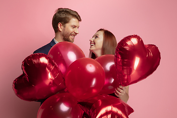 Image showing Valentine\'s day celebration, happy caucasian couple isolated on coral background