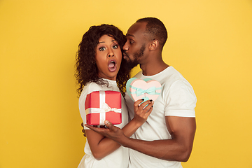 Image showing Valentine\'s day celebration, happy african-american couple isolated on yellow background