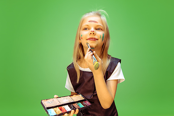 Image showing Little girl dreaming about future profession of makeup artist