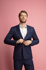 Image showing Portrait of young caucasian man isolated on coral background