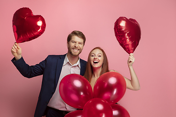 Image showing Valentine\'s day celebration, happy caucasian couple isolated on coral background