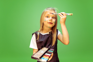 Image showing Little girl dreaming about future profession of makeup artist