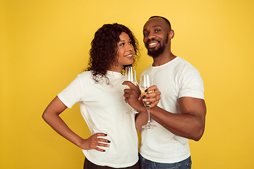 Image showing Valentine\'s day celebration, happy african-american couple isolated on yellow background