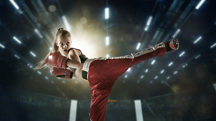 Image showing Young female kickboxing fighter training in the gym