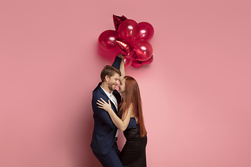 Image showing Valentine\'s day celebration, happy caucasian couple isolated on coral background