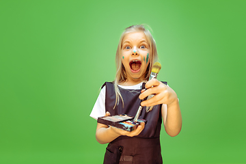 Image showing Little girl dreaming about future profession of makeup artist