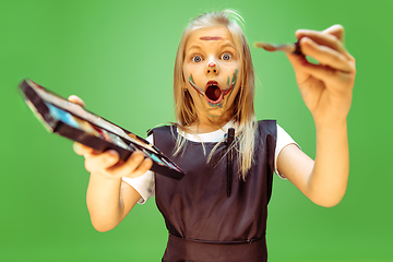 Image showing Little girl dreaming about future profession of makeup artist