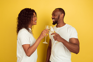 Image showing Valentine\'s day celebration, happy african-american couple isolated on yellow background