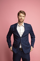 Image showing Portrait of young caucasian man isolated on coral background