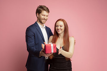 Image showing Valentine\'s day celebration, happy caucasian couple isolated on coral background