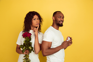 Image showing Valentine\'s day celebration, happy african-american couple isolated on yellow background