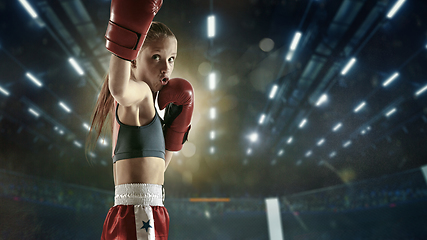 Image showing Young female kickboxing fighter training in the gym