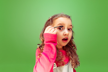 Image showing Little girl dreaming about future profession of makeup artist