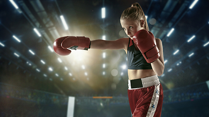 Image showing Young female kickboxing fighter training in the gym