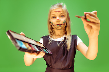 Image showing Little girl dreaming about future profession of makeup artist