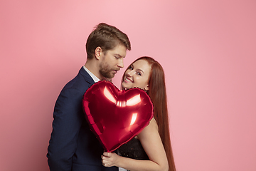 Image showing Valentine\'s day celebration, happy caucasian couple isolated on coral background