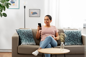 Image showing african american woman with smartphone at home