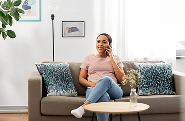 Image showing african woman calling on smartphone at home