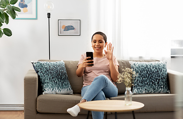 Image showing woman with smartphone having video call at home