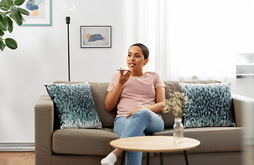 Image showing woman recording voice with smartphone at home