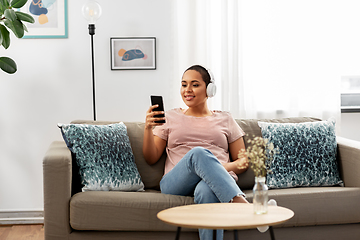 Image showing woman with smartphone listening to music at home