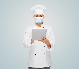 Image showing female chef in face mask with tablet pc computer