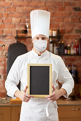 Image showing male chef in face mask with black menu chalk board