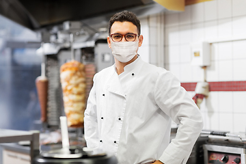 Image showing male chef with in face mask at kebab shop kitchen