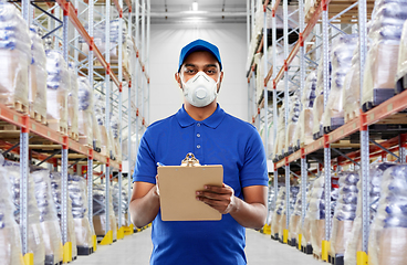 Image showing delivery man in mask or respirator at warehouse