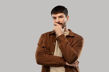 Image showing portrait of thinking young man with mustaches