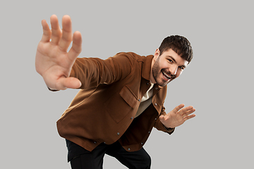 Image showing happy smiling young man with mustaches