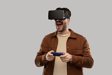 Image showing happy smiling young man in vr glasses with gamepad