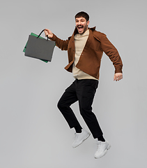 Image showing happy smiling young man with shopping bags