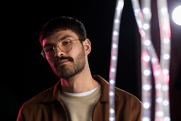 Image showing man in glasses over neon lights at nightclub