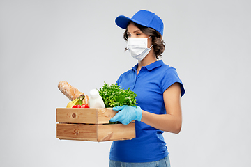 Image showing delivery woman in face mask with food in box