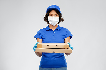 Image showing delivery woman in face mask with pizza boxes