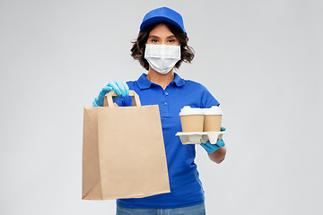 Image showing delivery woman in face mask with food and drinks