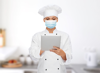 Image showing female chef in face mask with tablet pc computer