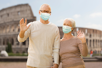 Image showing senior couple in protective medical masks in italy