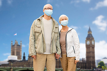 Image showing senior couple in medical masks in london