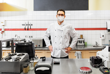 Image showing male chef with in face mask at restaurant kitchen