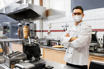 Image showing male chef with in face mask at kebab shop kitchen